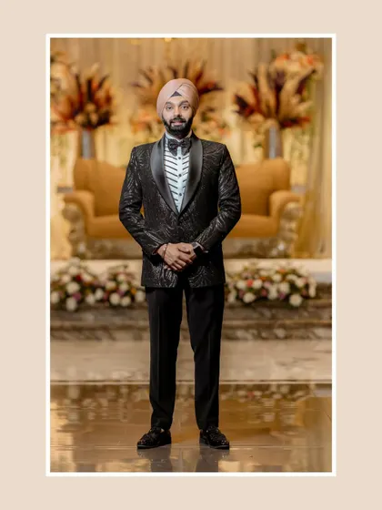 A classic, full-length portrait of the groom. His formal tuxedo and poised stance exude timeless elegance and sophistication.