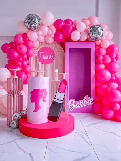 Come on Barbie, let's go party. I designed this vibrant pink Barbie-themed setup, complete with a life-size doll box for photos, disco balls, and a lipstick prop, making it a dream come true for any Barbie fan.