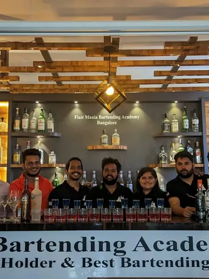 Students and instructors from our Bangalore academy posing behind the bar.