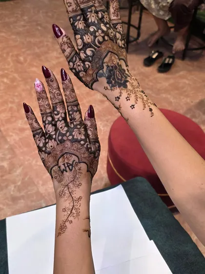 A beautiful floral vine design that flows from the wrist up the arm, paired with a full-coverage design on the other hand. This shows how we can mix different styles.