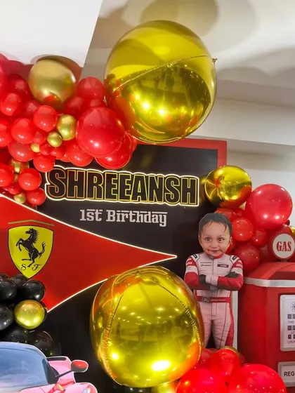 A detailed shot showing the personalized "Shreeansh 1st Birthday" backdrop and the custom cutout of the child.
