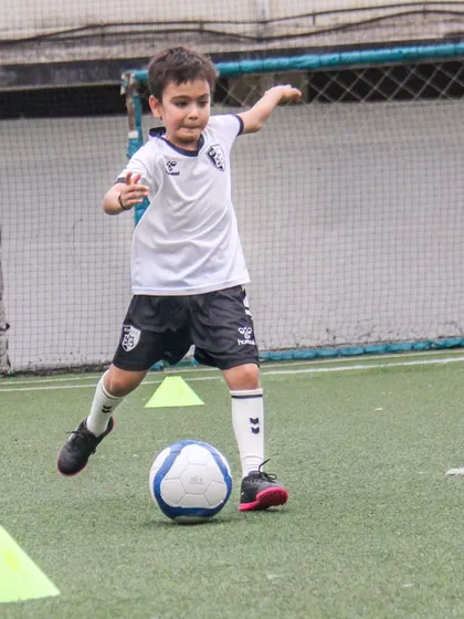 This player is about to strike the ball, showing the proper technique and body shape for a powerful and accurate shot.
