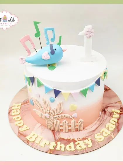 A sweet Mickey Mouse-themed cake for a first birthday. This design features Baby Mickey, a blue balloon, and peacock feathers for a unique and adorable touch.