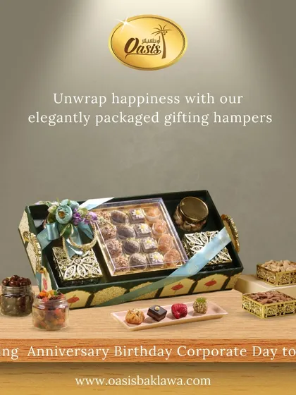 Unwrap happiness with my elegantly packaged gifting hampers. This image features a green and gold tray filled with assorted sweets and jars of treats, perfect for any celebration.