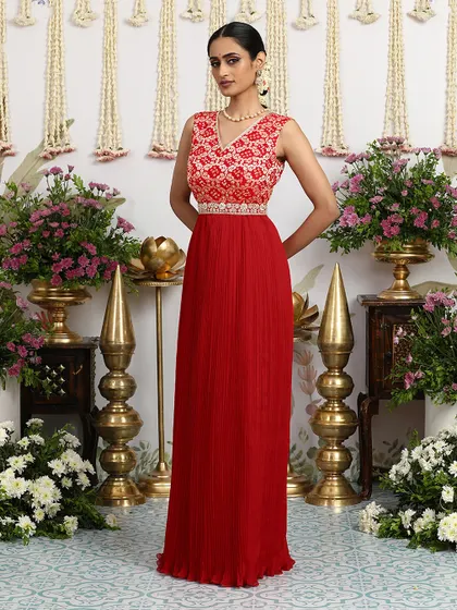 A standing pose that highlights the elegant silhouette of our red Bandhani gown.