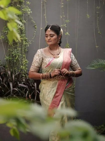 A professionally shot portrait that captures the dreamy quality of the bride's look. The makeup is soft and romantic, perfect for this garden setting.