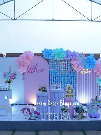 A full view of an outdoor unicorn-themed stage. The open-air setting allows the pastel colors to really pop.