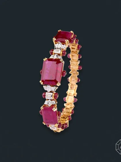 This ruby bangle blends the fiery passion of red gemstones with a sleek, sophisticated design, effortlessly elevating any ensemble.