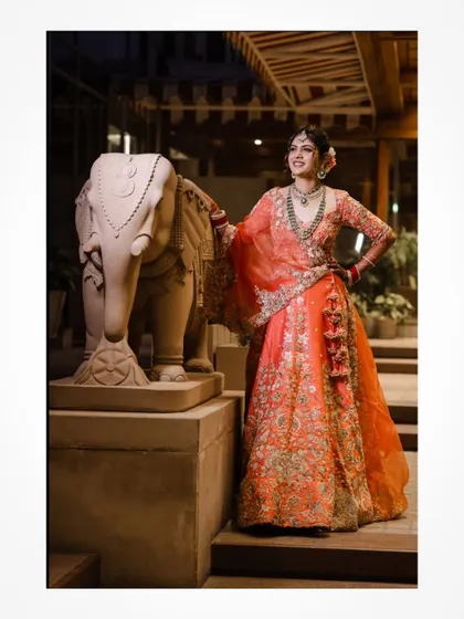 A stylish bridal portrait next to a decorative elephant statue.