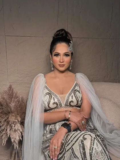 One of my all-time favorite looks. This client is wearing a unique white and gold outfit, and I complemented it with a sophisticated high bun and glamorous makeup.