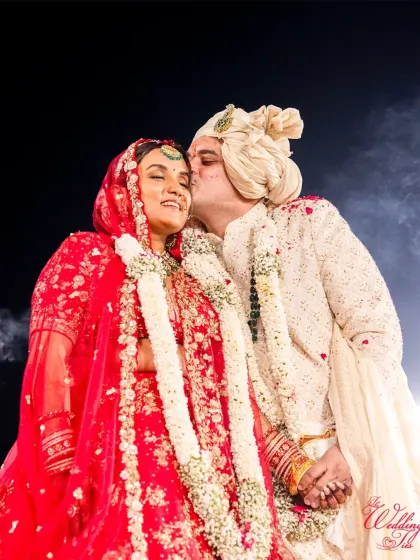 A happy, candid kiss from the groom after the wedding ceremony.