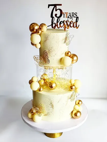 A shining cake for a shining 75th birthday celebration, but the white and gold theme is timeless for anniversaries too. This cake travelled fully assembled for 2 hours to the venue!
