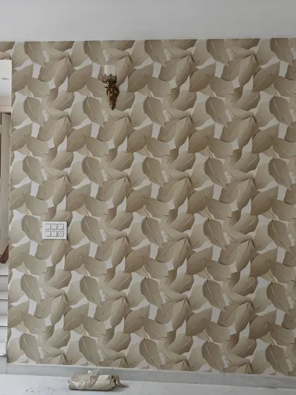 A full wall covered in a large-scale, neutral-colored leaf pattern. This creates a textured and organic feel, making the room feel more connected to nature.