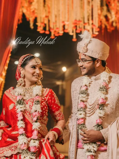 A beautiful candid moment between the bride and groom during their varmala ceremony. Their shared glance is full of love and happiness.