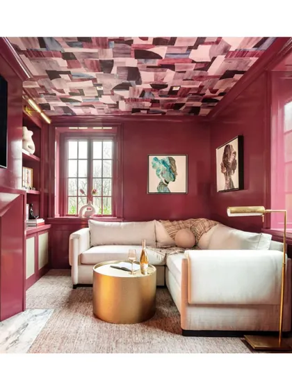 This living room demonstrates how wallpaper on the ceiling can elevate a space. The abstract, colourful pattern adds a surprising and artistic element, drawing the eye upward and making the room feel more dynamic.