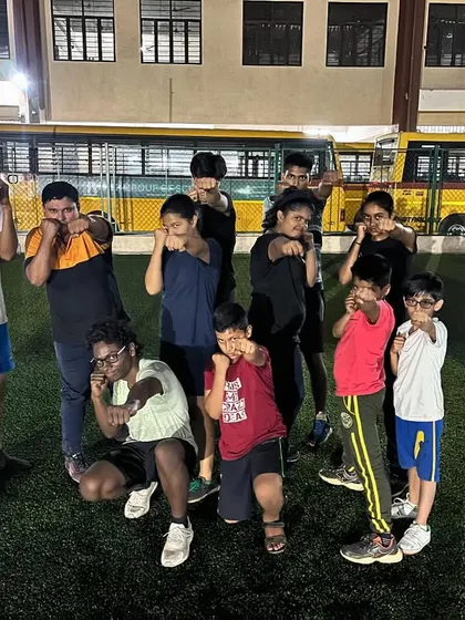This is our team, our family. A group of our summer camp boxers posing after a tough session. We train hard together and support each other, creating a positive and motivating environment for everyone.