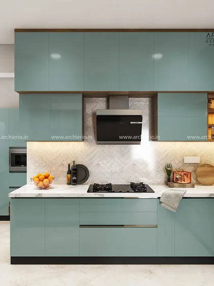 A beautiful kitchen with pastel blue lacquered glass cabinets and a white marble-patterned backsplash. The design is fresh, modern, and full of light.