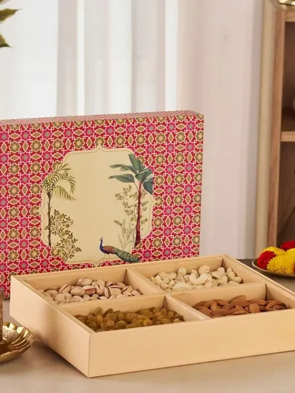 A beautifully designed dry fruit box with four compartments filled with pistachios, cashews, raisins, and almonds, perfect for traditional corporate gifting.