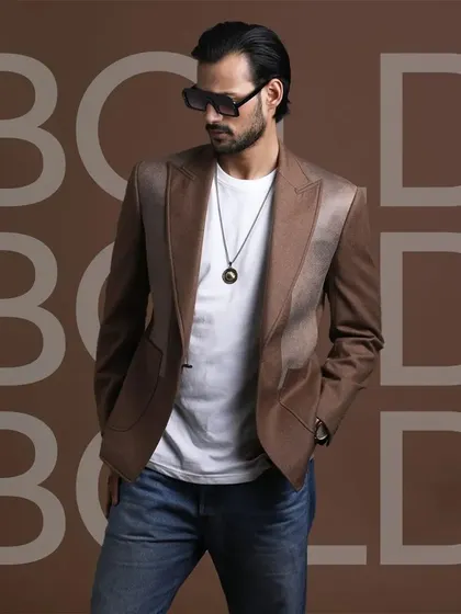 A brown blazer with unique satin lapel details. This piece is designed for the man who wants to make a bold and stylish statement.