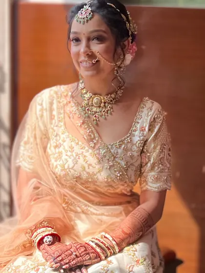 A happy, smiling bride. Her makeup is designed to look fresh and radiant, perfect for a daytime wedding.