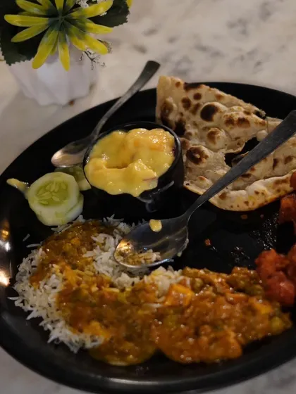 A plate filled with our delicious buffet lunch, including rice, curry, naan, and starters. We ensure there's something for every palate.