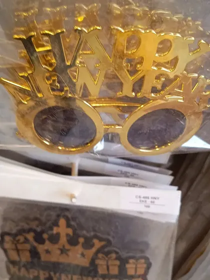 Shiny gold 'Happy New Year' glasses. These are a classic party favor that everyone will love to wear as the clock strikes midnight.