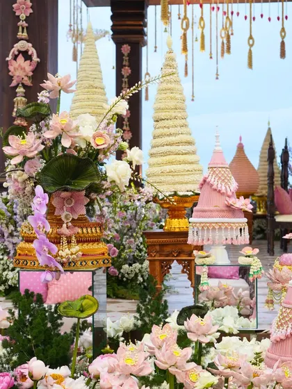Intricate, handcrafted floral towers and arrangements in shades of pink and white, created for the Vietnamese-Indian wedding ceremony.