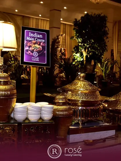 A luxurious setup for our Indian main course station, featuring ornate gold urns and chafing dishes. This presentation is designed to create a sense of grandeur and opulence at your event.