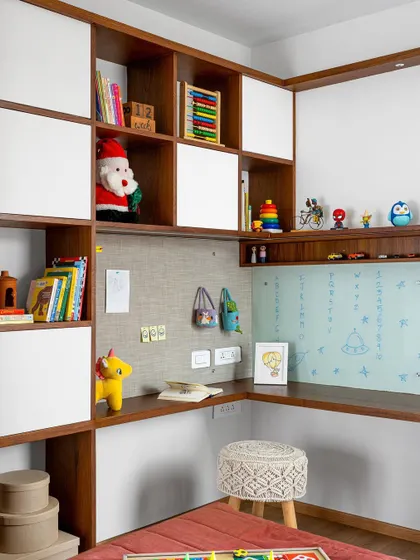 The kid's room in 'Gulmohar' is a checkered game of fun and functionality, with an elaborate study unit that includes a pin-up board, a glass writing board, and plenty of storage.