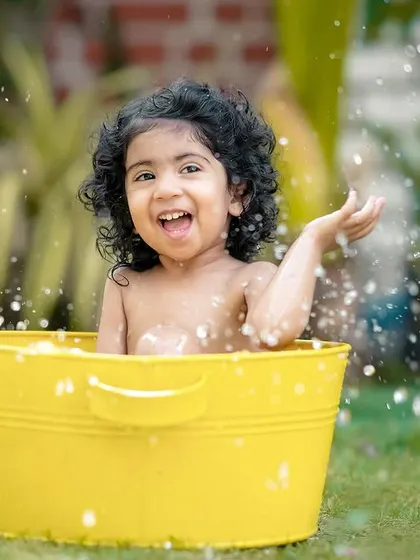 The smile on her face says it all! Our water splash sessions are guaranteed to bring out the happiest expressions.