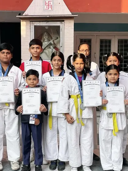 Distributing certificates to students who successfully completed their taekwondo training. Each certificate represents a step forward in their journey of self-empowerment.