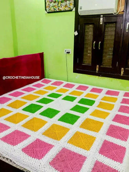 This bright and cheerful crochet bedsheet was made for a client's bedroom. The pattern uses solid granny squares for a modern, geometric look that is both warm and stylish.