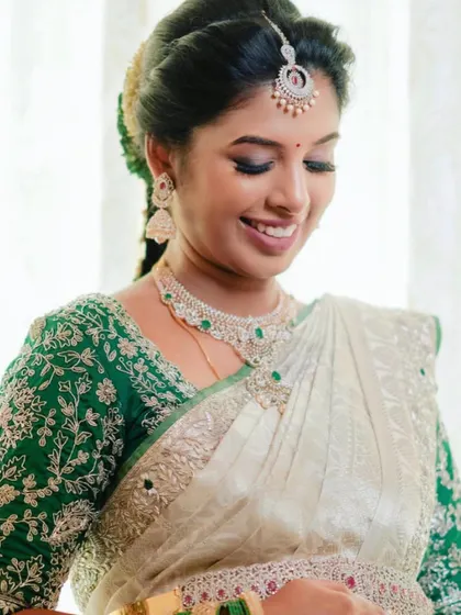 A close-up of Swathi's makeup, featuring a soft eye look and a bright smile.