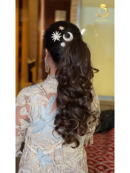 Another angle of the celestial-themed ponytail, showing how the accessories are placed to complement the hairstyle's shape and texture.