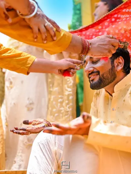The traditional 'tilak' during the groom's Haldi ceremony. I focus on capturing the details of these important rituals, preserving the cultural significance of the wedding.