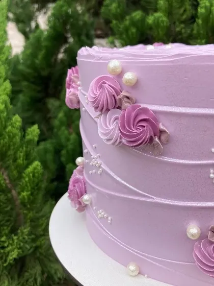 A close-up of the delicate piping work on my lilac cake. The combination of textures, swirls, and edible pearls creates a design that is both elegant and visually interesting.