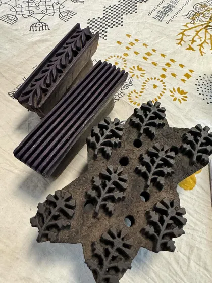 A selection of hand-carved wooden blocks used for Dabu and Bagru printing. Each block, with its intricate design of leaves, borders, and motifs, is a work of art in itself.