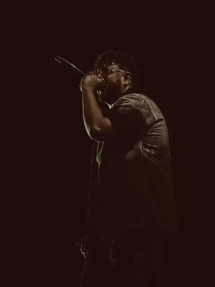 In my element, under the lights with the mic in my hand. This is where I speak my truth, one bar at a time, during an intense rap performance.
