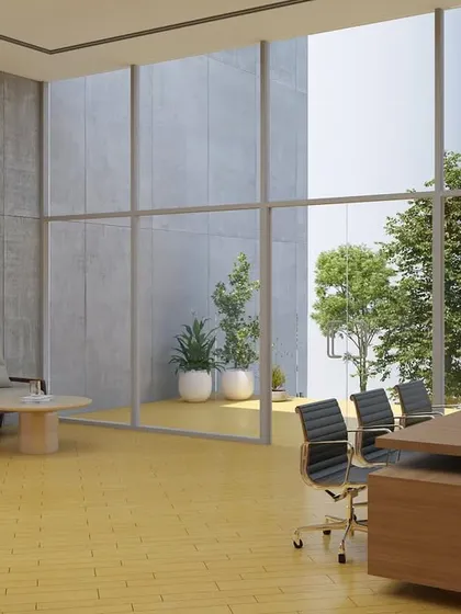 An executive office rendering for JSW Nagaur, with full-height windows offering expansive views of the landscaped exterior. The design ensures that even senior management spaces are connected to nature.