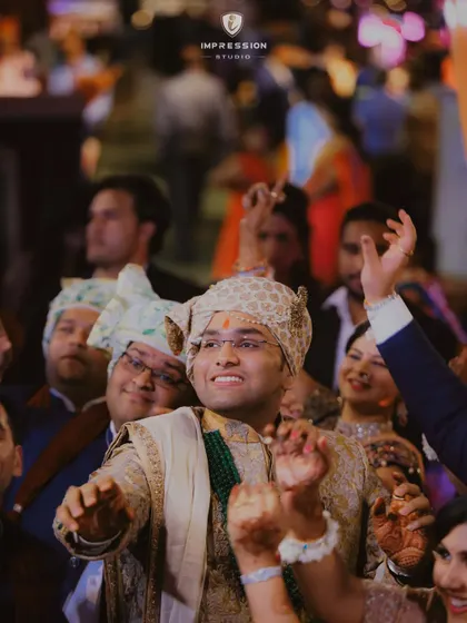 The groom lost in the music and the moment. I focus on capturing the energy and happiness of everyone involved, especially the groom's joyous celebration on his big day.