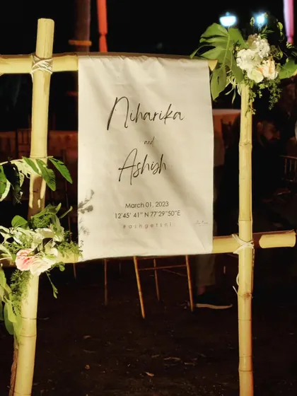 A rustic yet chic welcome sign for Niharika and Ashish's cocktail night. We used a simple bamboo frame and a custom-printed canvas sign that included the event's coordinates for a unique, personal touch.