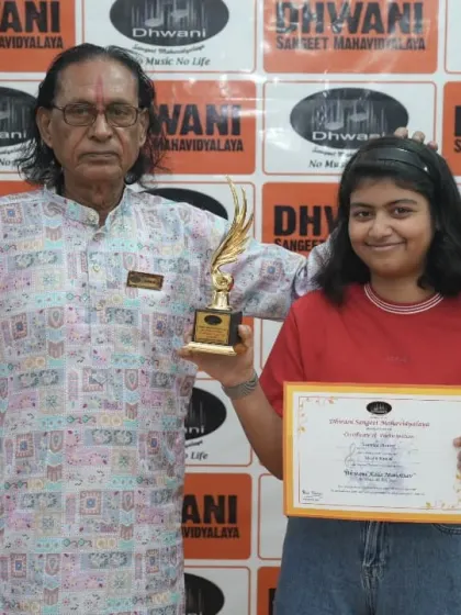 A senior guru with his student, celebrating her success.