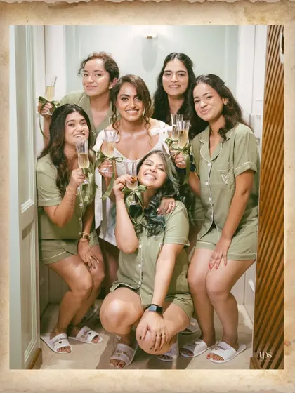 The bride and her bridesmaids in matching pajamas, sharing a laugh and a toast. A perfect capture of the fun and relaxed moments before the ceremony.
