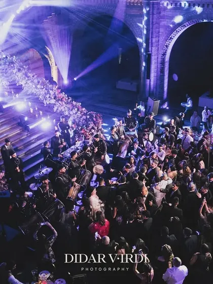 An overhead view of the packed dance floor at the Natural History Museum. This shot captures the scale of our lighting production, with beams of light creating texture and energy throughout the massive hall, drawing everyone to the party.