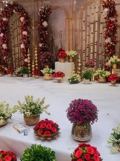 A look at the floral arrangements used for the engagement ceremony, including bouquets in brass vases and larger floor arrangements.