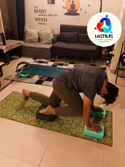 A client works on a challenging core and hip flexor stretch, using blocks for support.