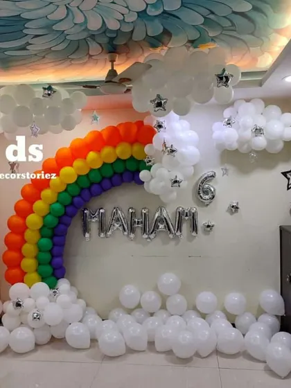 A spectacular rainbow and clouds balloon wall created for a 6th birthday. This large-scale installation transforms an entire wall into a magical sky scene.