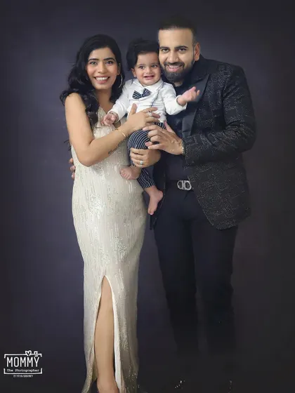 A glamorous family portrait. This family looks so stylish and happy in their formal wear during this classic studio photoshoot.