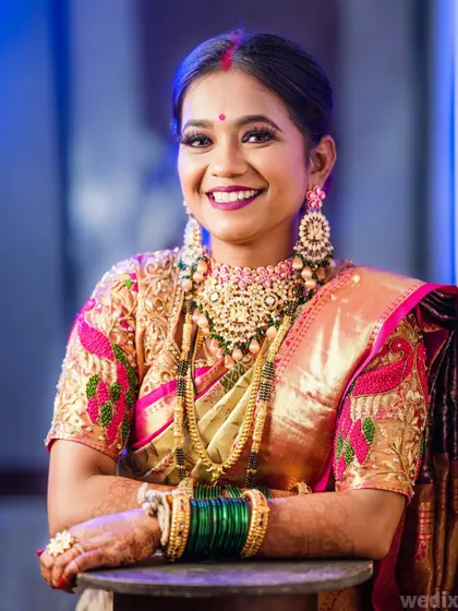 A stunning reception look. This portrait captures the bride's glamorous makeup and heavy jewellery against a cool blue background.
