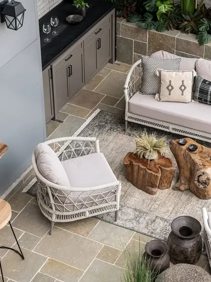 At the core of the home, the deck serves as a focal point with its inviting combination of a warm vanilla limestone floor and a mobile bar, perfect for vibrant social gatherings.